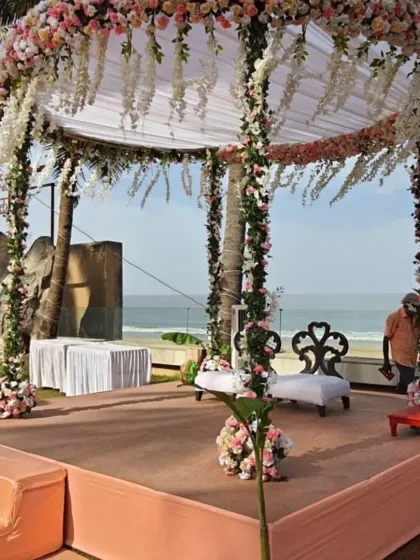 This beachside mandap is a perfect example of modern romance. We used a circular structure wrapped in lush pink and white florals with delicate hanging wisteria, creating a beautiful frame for the couple against the ocean backdrop.