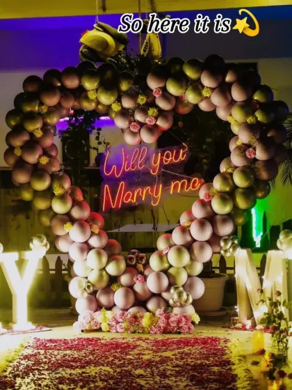 A closer look at the heart of the celebration. This heart-shaped balloon arch frames a custom "Will you Marry me" neon sign, creating a perfect focal point for the most important question.