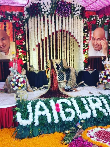For this outdoor satsang, I created a vibrant stage with red and white floral pillars. The highlight is the "JAI GURU JI" message written entirely with fresh white flowers, placed right at the front of the stage.