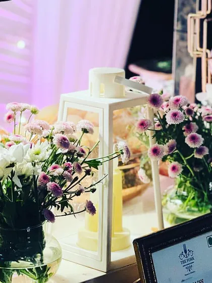 Details matter. Fresh floral arrangements in glass vases and candle-lit lanterns are just a few of the small touches I use to beautify the buffet and enhance the dining experience.