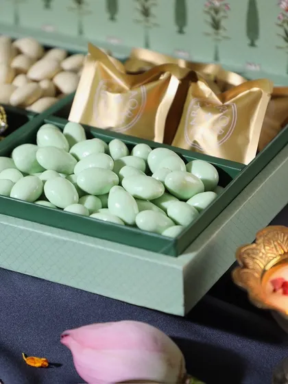 A close-up of our premium Pista White Chocolate Almonds, a popular item in our festive hampers. The quality and flavor speak for themselves.