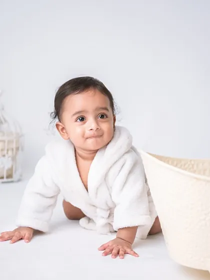 All wrapped up in a cozy white robe after a fun splash. This setup is simple, clean, and focuses entirely on your baby's adorable post-bath look.