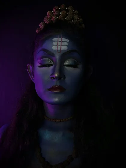 A serene and powerful depiction of Lord Shiva. The student used blue body paint and subtle contouring to create this divine look.