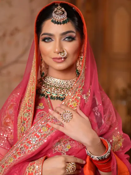 With her head covered, the focus shifts entirely to her face. The makeup is designed to be captivating, with intense eyes and a radiant complexion that shines through.