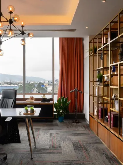 An executive cabin should feel powerful and inspiring. I designed this space with a stunning view, a bold sputnik chandelier, and a custom gold-finished shelving unit that adds a touch of luxury without being stuffy. It’s a workspace that makes a statement.