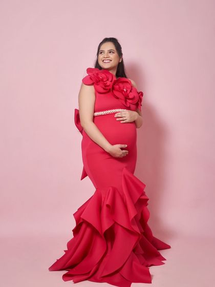 A full-length view of the Gabriel gown. The large floral details on the shoulder and the ruffled mermaid tail make this a true statement piece.