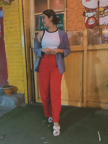 Keeping it cool in the summer heat with this casual and chic outfit. A simple crop top paired with bold red pants and a lightweight blue shirt as a layer is perfect for a day out.