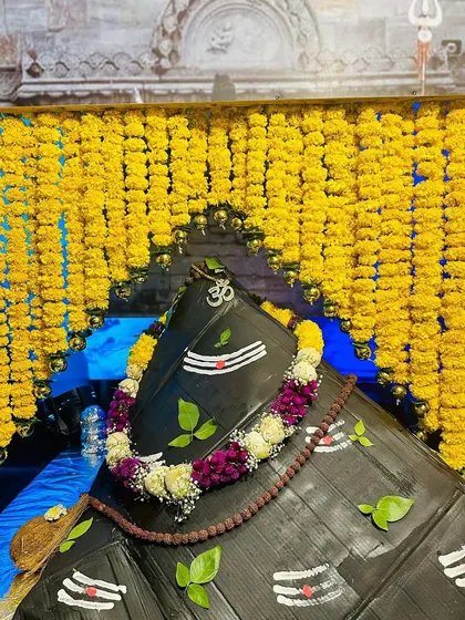 The archway for the shrine was constructed entirely from strings of bright yellow marigolds, a flower symbolic of the sun and divine blessings in Hindu traditions.