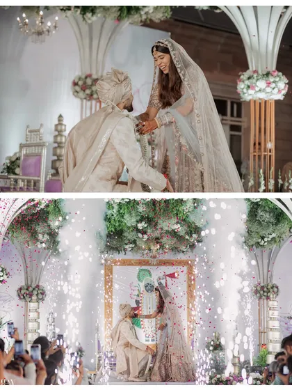 The bride and groom exchange garlands during the Varmala ceremony, surrounded by celebratory sparklers.