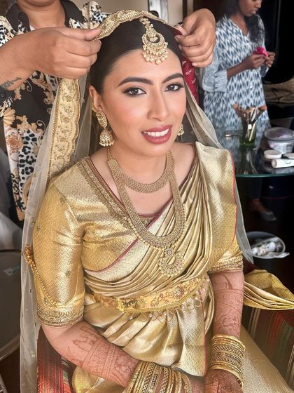 A sun-kissed Nikah look. The bride is glowing in her all-gold ensemble, with makeup that is warm, radiant, and absolutely timeless.