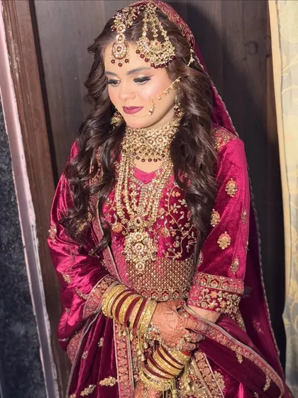 This Nikkah bride opted for a deep magenta velvet lehenga. I complemented it with a matching bold lip, soft smoky eyes, and long, flowing curls for a romantic and royal look.