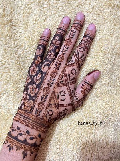 A contemporary bridal design combining multiple patterns. It features a mix of floral nets, geometric lines, and leafy vines for a rich, textured look.