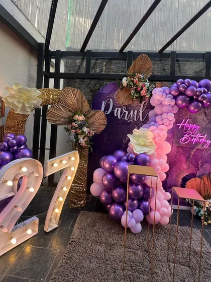 The full view of the stylish 27th birthday setup with large light-up marquee numbers.