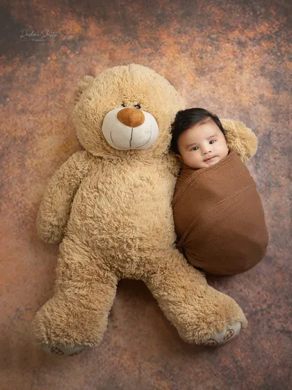 Best friends already. Posing a tiny newborn next to a giant teddy bear is a wonderful way to show just how small and precious they are.
