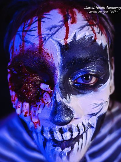 The same SFX skull look under blue lighting, creating a spooky and cinematic effect. We teach students about lighting and how it interacts with their makeup creations.