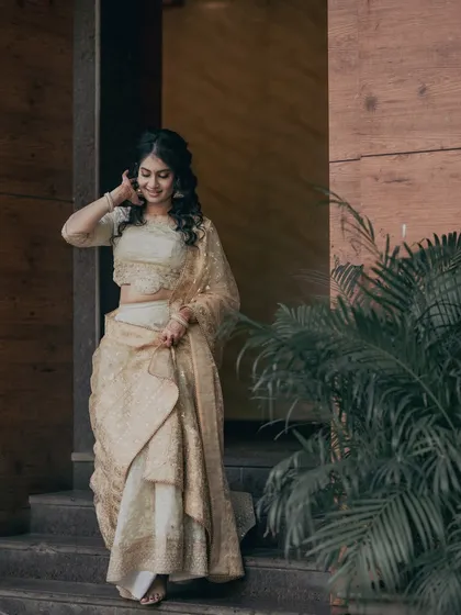 A candid moment of Kavya descending the stairs. Her soft glam makeup looks beautiful in motion, proving that a great look is perfect for both posed and candid shots.
