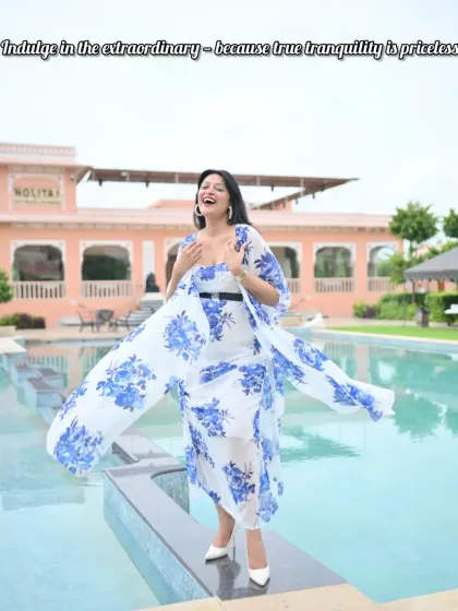 A joyful moment by the pool in a blue and white floral co-ord set. The flowing fabric of the cape adds beautiful movement, making it perfect for a vacation photoshoot.