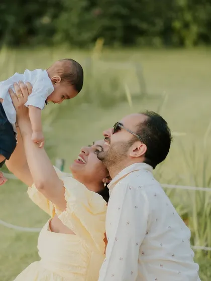 Flying high with mom and dad. This joyful shot is full of energy and love.
