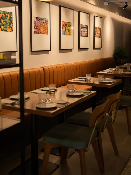 Our cozy dining space, with its warm leather banquettes and carefully chosen decor, ready to welcome you for a meal.