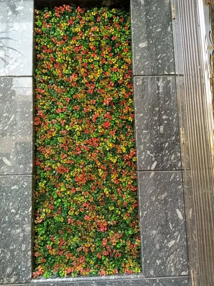 A close-up of the multi-colored artificial plants used for an indoor floor planter.