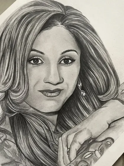 An angled view of the same portrait, showing the artwork on the paper and giving a sense of its texture and finish.