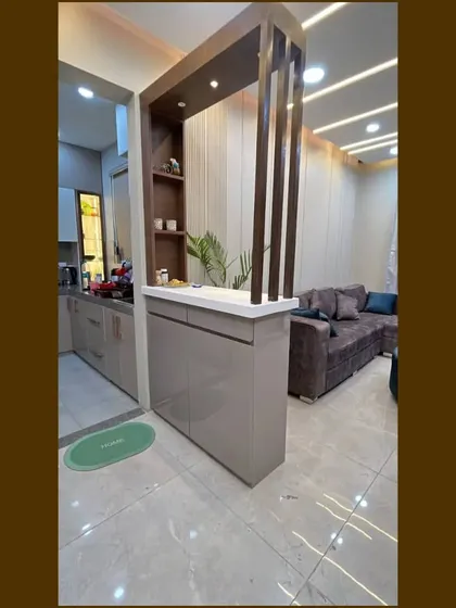 A full shot of the partition we designed for our Gurgaon site, which helps define the kitchen entrance while offering counter space and storage.