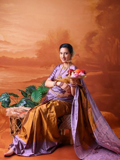 A classic portrait evoking Indian tradition and hospitality. The mom-to-be holds a tray of fruit, a symbol of abundance and life, while dressed in a beautiful saree.
