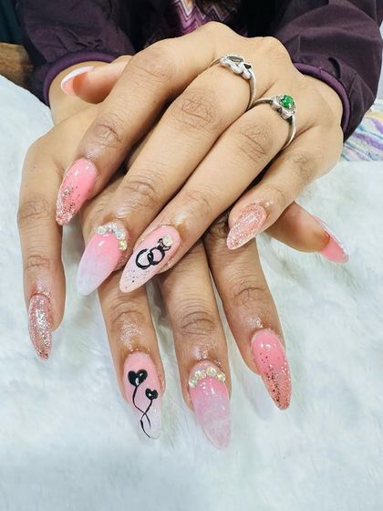 I created these custom engagement-themed nails with a soft pink ombre and glitter accents. The design features hand-painted interlocking rings and hearts, symbolizing the special occasion.