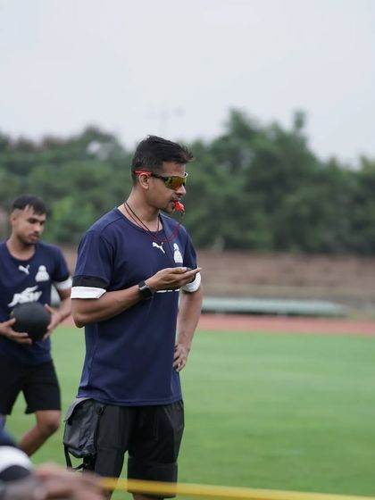 Whistle in mouth, stopwatch in hand. A typical day at the office, overseeing a conditioning session.