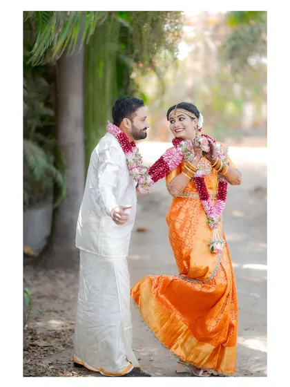 A playful and fun shot of the couple, with the bride kicking up her heel, showcasing their joyful personalities.