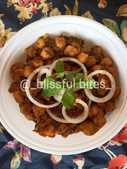 My street-style Chana Batata is a tangy and spicy chickpea and potato snack, garnished with fresh onion rings and mint.