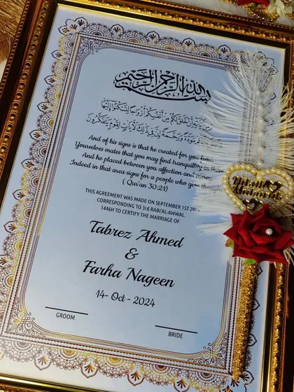A close-up of the personalized Nikah certificate, highlighting the Quranic verse and the couple's names. The decorative pen adds a final touch of artistry.