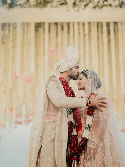 A moment of pure love and blessing during the Varmala ceremony. The groom's kiss on his bride's forehead is a powerful, emotional gesture that I always look to capture.