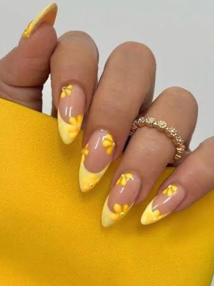 This set features bright yellow French tips on almond-shaped nails, decorated with delicate, hand-painted 3D flowers. It's a cheerful and trendy look for the summer season.