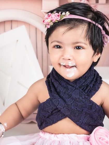 A sweet, messy smile from the birthday girl during her princess castle cake smash. These are the moments of pure, unfiltered joy.