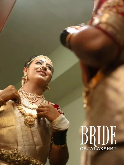 A beautiful candid shot of the bride looking in the mirror, getting ready for her big moment. Her happy and confident smile says it all.