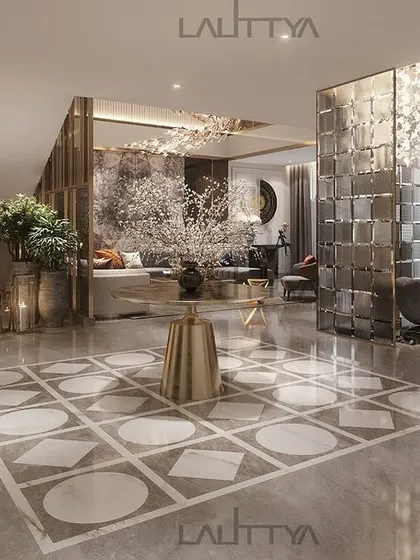This open-concept foyer design showcases how we create flow and elegance. The sleek marble floor with a geometric inlay leads the eye from the entrance towards the living area, with a sculptural glass partition adding a touch of modern artistry.