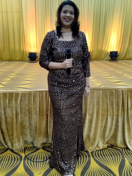 Dressed for a glamorous Sangeet night, I am ready to get the party started. I specialize in managing the flow of performances and keeping the energy high for wedding festivities.