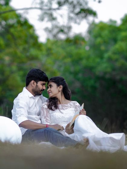 Lost in each other's eyes during a romantic outdoor picnic shoot. These are the genuine, unposed moments I strive to capture.