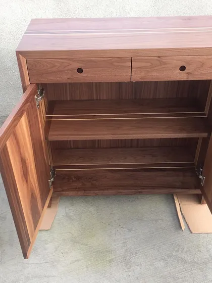 This solid walnut sideboard was part of a larger commission for the Irish Embassy in London. It features a delicate ash inlay detail and felt-lined drawers, showcasing the level of precision and finish I bring to freestanding furniture projects.