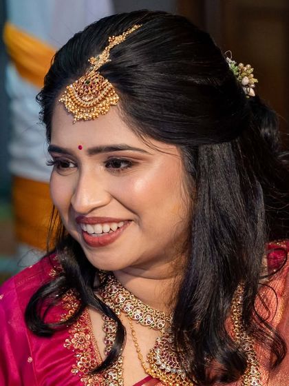 A radiant smile from this bride, her minimalistic makeup enhancing her natural beauty.