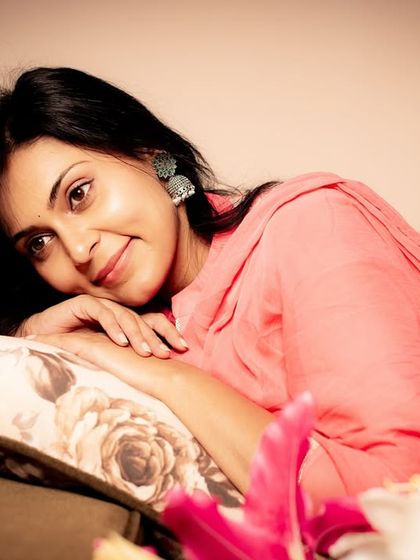 A warm and inviting portrait. The soft smile and relaxed pose create a feeling of comfort and intimacy.