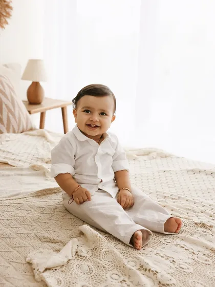 A quiet moment of pure happiness. This simple portrait of a baby boy in a cozy, light-filled bedroom setting captures his sweet and content personality. Sometimes the simplest shots are the most powerful.