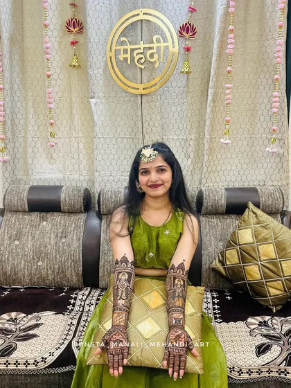 A happy client showcasing her full-arm 'Vithu namachya rangat' mehandi design. This piece is perfect for religious ceremonies, festivals, or as a unique bridal design.