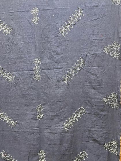 The full panel of the grey Mangalgiri cotton saree with Sashiko embroidery. The diagonal and vertical arrangement of motifs creates a modern, graphic effect.