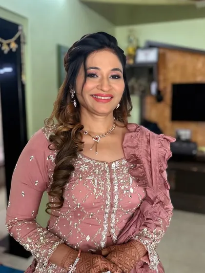 A smiling portrait showing her complete look. She looks graceful and happy.