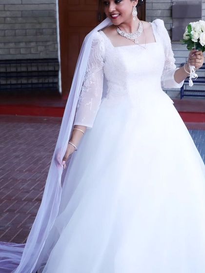 The same beautiful bride, glowing with joy. The fit of the gown and the way the light catches the delicate embroidery on the sleeves is just perfect.