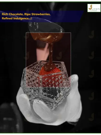 Refined indulgence in a glass. This dessert features ripe strawberries layered with rich chocolate sauce in an elegant crystal-cut glass.