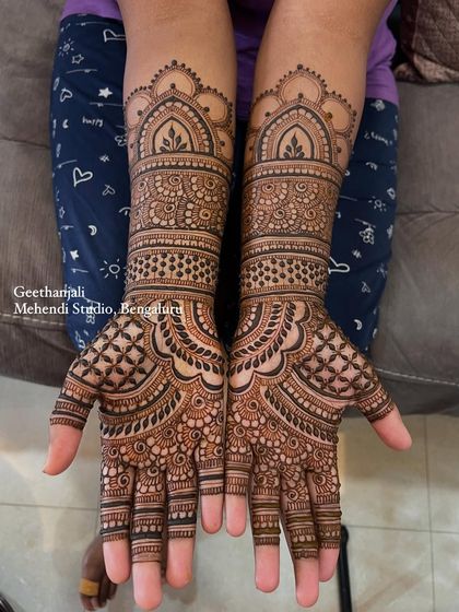 A beautiful and intricate design for an engagement, featuring classic patterns and full coverage up to the mid-arm.