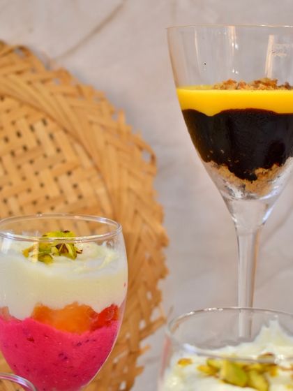 A closer look at the beautiful layers in my glass desserts. On the left, a vibrant fruit parfait; on the right, a decadent chocolate and mango creation.